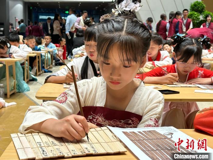 圖為小朋友在甘肅簡牘博物館練習(xí)書法?！≈行律缬浾?戴文昌 攝